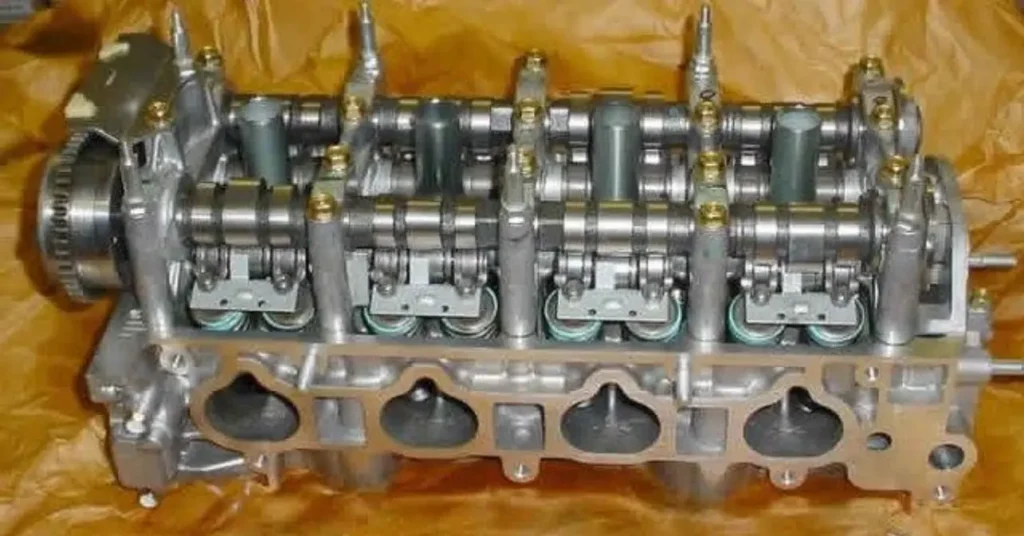 A cylinder head assembly, showing valvetrain components like camshafts, valves, and springs.