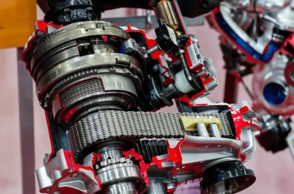 A cutaway view of a transfer case, revealing its internal components such as gears, chains, and shafts. The housing is partly removed to show the intricate mechanics inside.